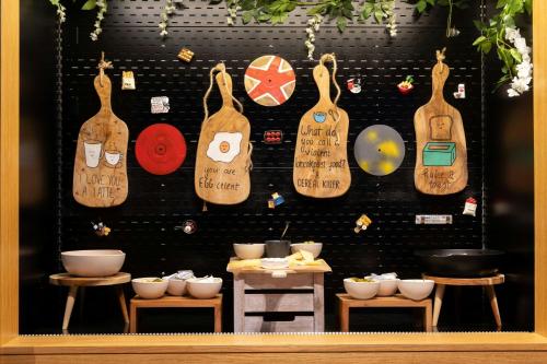 a wall with a bunch of wooden utensils on it at Moxy Glasgow Merchant City in Glasgow