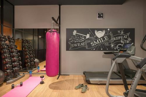 a gym with a pink punching bag and a treadmill at Moxy Glasgow Merchant City in Glasgow