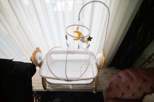 a white chair sitting in front of a window at Golden Hill Palace in Novi Pazar