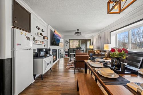 a kitchen and living room with a table and a refrigerator at Corner Unit Balcony Free Tix Gatlinburg in Gatlinburg