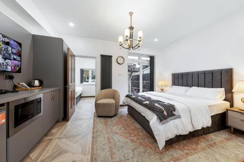 a bedroom with a large bed and a tv at Apple Tree House 2 in Ilford