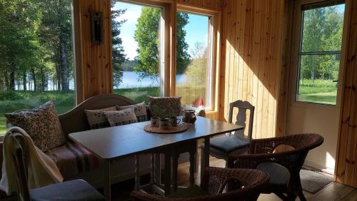 a living room with a table and chairs and a couch at The hunters-lodge in Ludvika