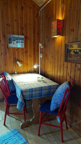 a table in a room with two chairs and a table with at The hunters-lodge in Ludvika