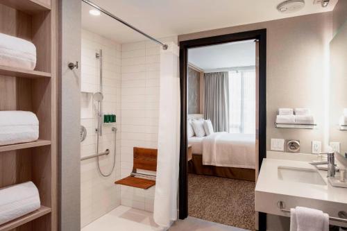 a bathroom with a shower and a sink and a toilet at Residence Inn by Marriott Calgary Downtown/Beltline District in Calgary