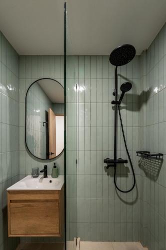a bathroom with a shower with a sink and a mirror at 2 Bed 2 Bath / Luxury / 1 min walk to BTS Asok in Bangkok