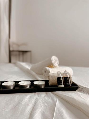 a tray with a towel and a spa set on a bed at O5 residence in Nivy