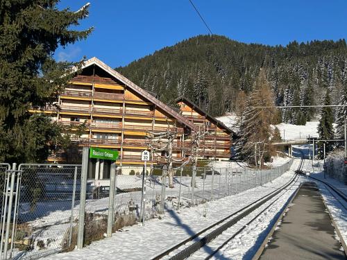 a log cabin in the snow next to a fence at Central studio in Villars sur Ollon, Emeraude, for 3 only 100m to Bretaye ski train in Villars-sur-Ollon