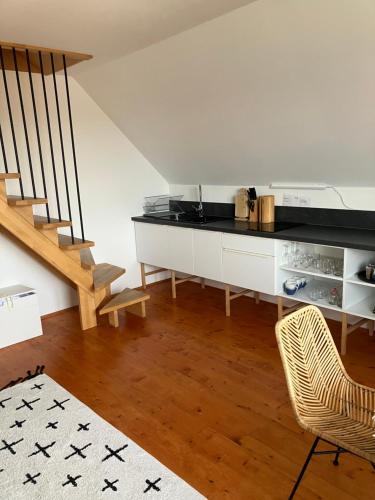 a living room with a counter and a staircase at Tatraview House in Veľká Lomnica