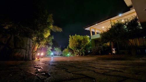 an empty street at night with lights on a building at Wasantha Holiday Inn in Kalutara