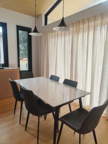 a dining room with a table and chairs at The Pampines Villa, Mount Kinabalu in Ranau