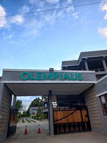 a sign for a gymnasium with orange cones in front at Olempiaus Gardens Hotel in Mai Mahoro