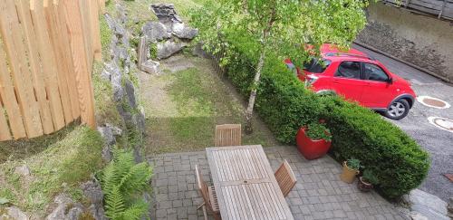 a red car parked on a street with a table at Ronchet Baita Vanoi Trentino in Ronco