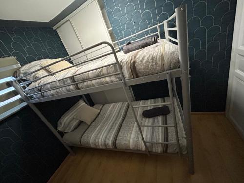 a bunk room with two bunk beds in it at Villa Maxonale pour séjour famille uniquement in Villemoisson-sur-Orge