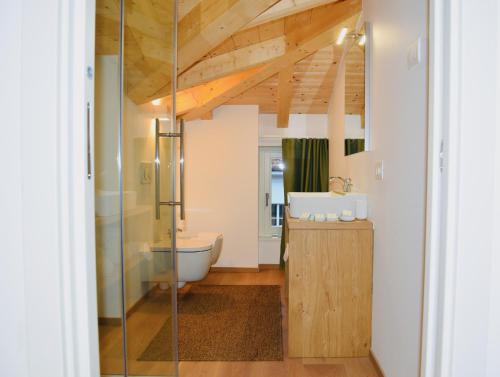 a bathroom with a shower and a toilet and a sink at Nine Rooms Suite in Trento