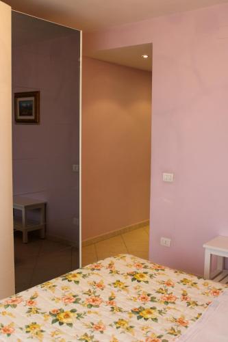 a bedroom with a bed and a mirror at B&B Il Panorama in Torremaggiore