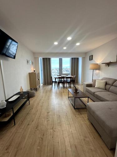 a living room with a couch and a table at À Deux Pas de la Plage, Appartement 2 Chambres, 6 Pers in Berck-sur-Mer