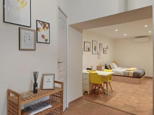 a bedroom with a bed and a desk and a table at Cabanon provençal in Rochefort-du-Gard