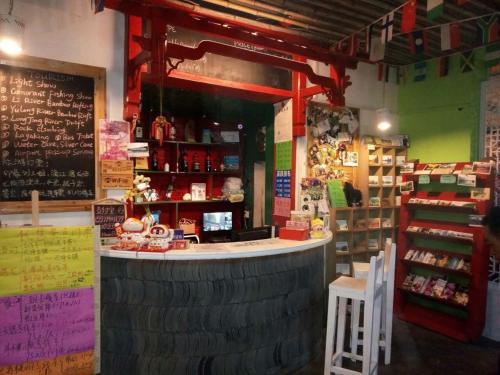 a store with a large stack of tires around a bar at Yangshuo How Flowers Hostel in Yangshuo