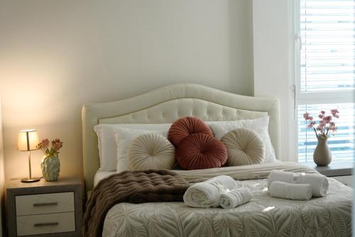 a bedroom with a bed with pillows and towels on it at Lakeside Attic in Lugano
