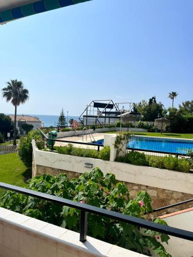 a resort with a pool and a playground at "La Cala de Mijas Bright Apartment with Sea Views Near the Beach" in La Cala de Mijas