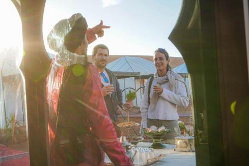 a man and a woman standing in front of a table at Aladdin merzouga camp in Merzouga