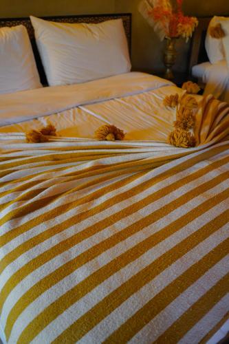 two stuffed animals laying on top of a bed at Aladdin merzouga camp in Merzouga