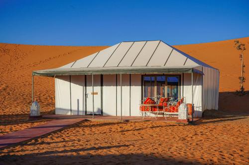 a small building in the middle of a desert at Aladdin merzouga camp in Merzouga