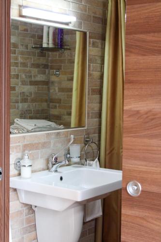 a bathroom with a white sink and a mirror at B&B Il Panorama in Torremaggiore