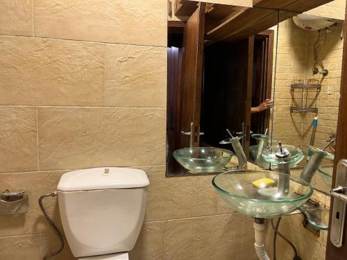 a bathroom with a toilet and a glass sink at Luxury Studio Zamalek in Cairo