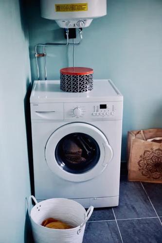 a washing machine with a basket on top of it at Tiny House with a Stunning Lake View 30 Min from Gothenburg in Gråbo
