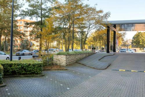 an empty street with cars parked on the road at Corendon Amsterdam New-West, a Tribute Portfolio Hotel in Amsterdam
