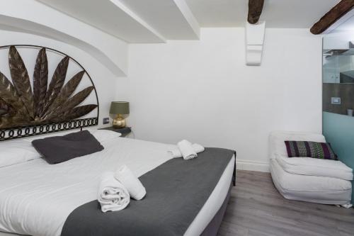 a bedroom with a white bed and a couch at WELLNESS HM wellness home By Dimorra in Naples