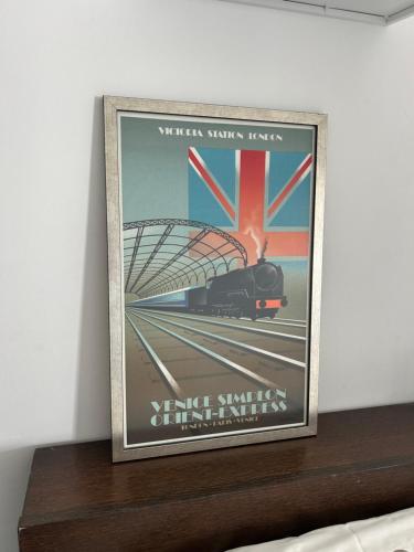 a framed picture of a train on a shelf at The Kingfisher -- Sea, Nature, You A relaxing vacation for up to 6 people in Giv‘at Olga