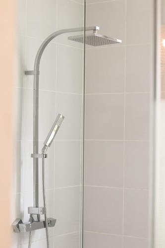 a shower with a shower head in a bathroom at Eskep Estate - Private Villas in Phumĭ Ŏng Char