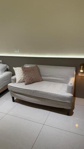 a couch with pillows on it in a room at 鹿港 尋鹿好旅 民宿 in Lugang