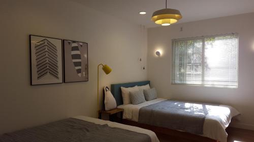 a bedroom with two beds and a window at Adellia Pension in Gyeongju
