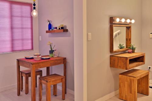 a dining room with a table and a mirror at Adellia Pension in Gyeongju