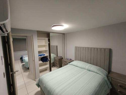 a small bedroom with a bed and a mirror at Puerto Vallarta Zona Romantica in Puerto Vallarta