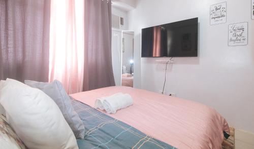 a bedroom with a bed with a towel on it at Eimy's Place at Urban Deca Mandaluyong by RedDoorz in Manila
