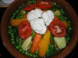 a bowl of vegetables with tomatoes and cauliflower at Hotel Espace Tifawine in Tafraoute