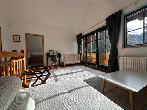 a living room with a couch and a window at Wapiti Chalet - Katschberg in Aschbach