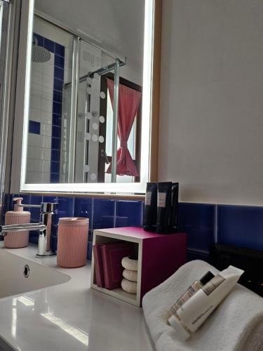 a bathroom with a sink and a mirror at Sa Mirada Apartments in Villasimius