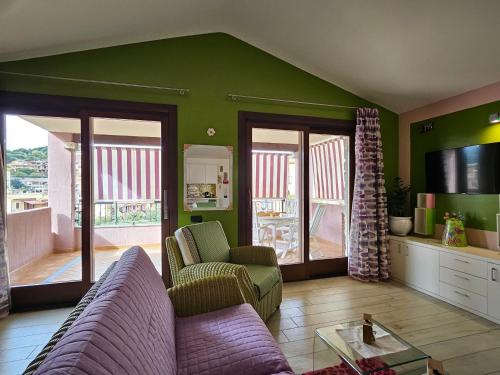 a living room with a couch and a tv at Sa Mirada Apartments in Villasimius