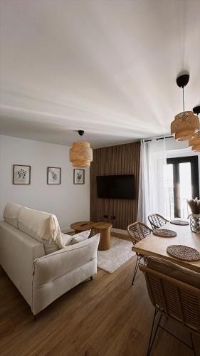 a living room with a couch and a table at La Casa del Escudo in Trujillo