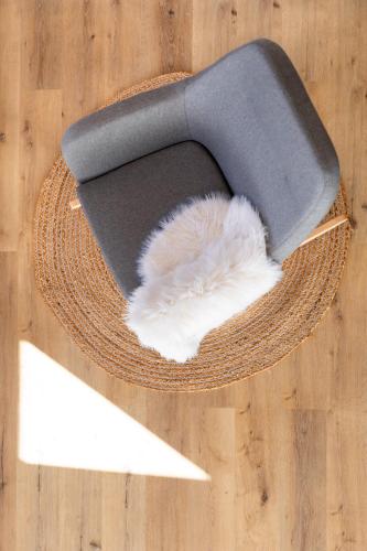 a hat with a feather on top of a wooden floor at The Cliff Village in Comarnic