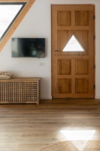 a room with a barn door and a tv at The Cliff Village in Comarnic