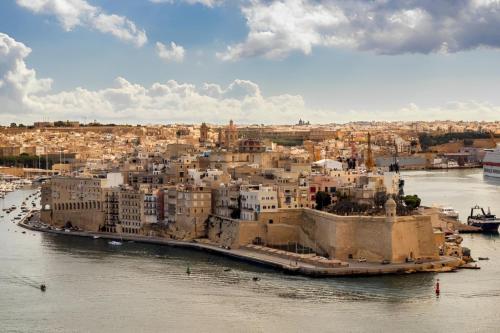an aerial view of a city next to the water at Industrial Cozy Gzira Apt, Prime Spot, Sep Deal in Il-Gżira