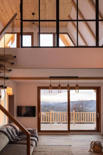 a room with a large window with a view at The Cliff Village in Comarnic