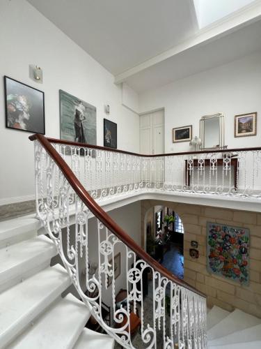 a staircase in a house with white walls at Stylish Boutique Duplex Apartment Home - Green - 2 Large Double Bedrooms with Ensuite Bathrooms in Msida