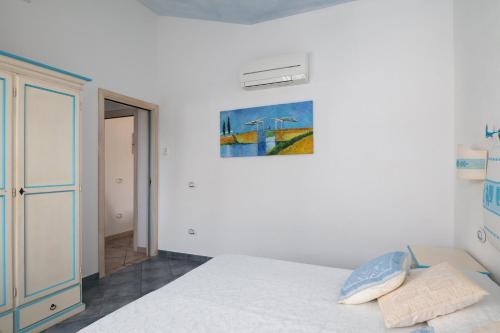 a bedroom with a bed and a painting on the wall at Residence Solaria in Budoni